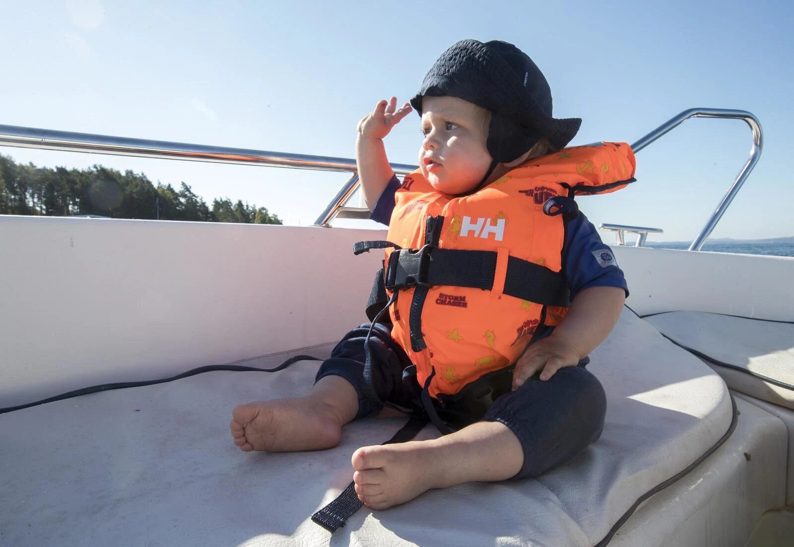Toddler wearing a properly fitted life jacket on a boat